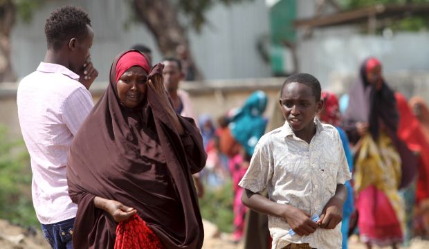 People react as they look at bodies at the scene of a car bomb attack in Hodan district in the capital Mogadishu on June 24, 2015. (Reuters/Feisal Omar)