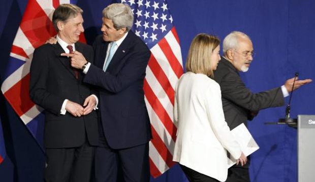 (L–R) British Foreign Secretary Philip Hammond, US Secretary of State John Kerry, EU High Representative for Foreign Affairs and Security Policy Federica Mogherini, and Iranian Foreign Minister Mohammad Javad Zarif, react during a press event after the end of a new round of Iran nuclear talks in the Learning Center at the Swiss federal Institute of Technology (EPFL), in Lausanne, Switzerland, on April 2, 2015. (EPA/Valentin Flauraud)