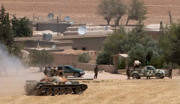 Kurdish People's Protection Units (YPG) fighters gather at the eastern entrances to the town of Tel Abyad of Raqqa province, Syria, on June 14, 2015. (Reuters/Rodi Said)