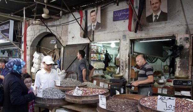 Syrians buy nuts and candies at the Bab Sreijeh souk in downtown Damascus, Syria, on June 23, 2015. (EPA/Youssef Badawi)