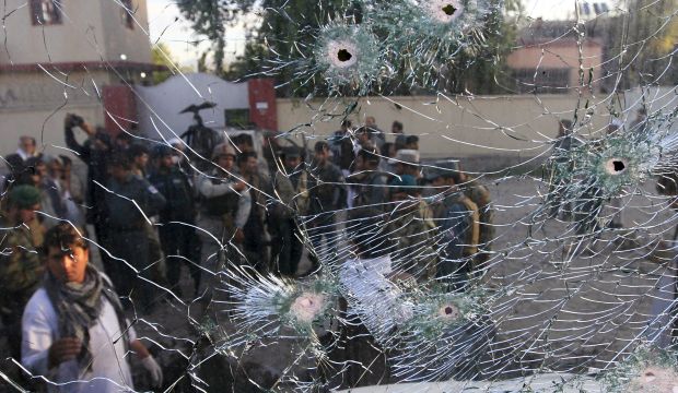 Afghan security forces are seen from a cracked side window of a vehicle, which was damaged in a suicide attack on a police headquarters in Jalalabad, Afghanistan on June 1, 2015. (Reuters/Parwiz)