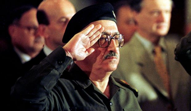 In this Dec. 2, 1998 file photo, former Iraqi foreign minister Tariq Aziz stands to attention as the Iraqi national anthem is played at a conference in Baghdad, Iraq. Officials say Aziz has died in a hospital in southern Iraq on Friday, June 5, 2015.  (AP Photo/Peter Dejong)