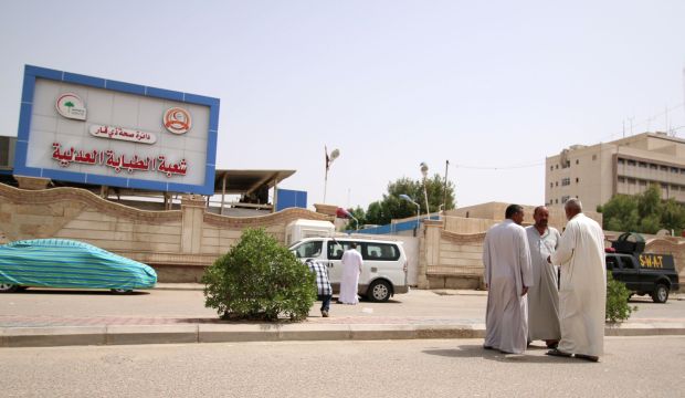 Iraqi special forces and locals stand outside a hospital in Nasiriyah where Iraq's former foreign minister Tariq Aziz died on June 5, 2015. (AFP/Haidar Mohammed Ali) 