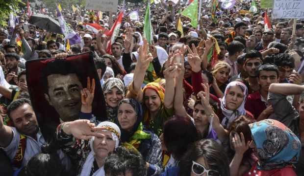 People wave and shows v-sign on June 3, 2015, in Mardin  during an election rally of the leader of the pro-Kurdish Peoples' Democratic Party (HDP) Selahattin Demirtas, ahead of the legislative election on June 7, 2015. (AFP Photo/Ilyas Akengin)