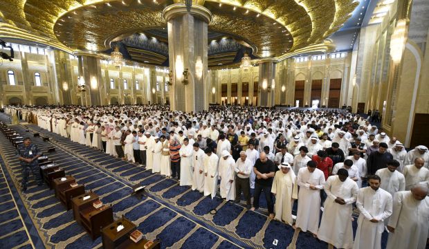 A special forces soldier stands as Sunni and Shi'ite worshippers, together with Emir Sheikh Sabah Al-Ahmed Al-Jabir Al-Sabah, pray at the grand mosque of Kuwait, in Kuwait City, on July 3, 2015. (Reuters/Jassim Mohammed)
