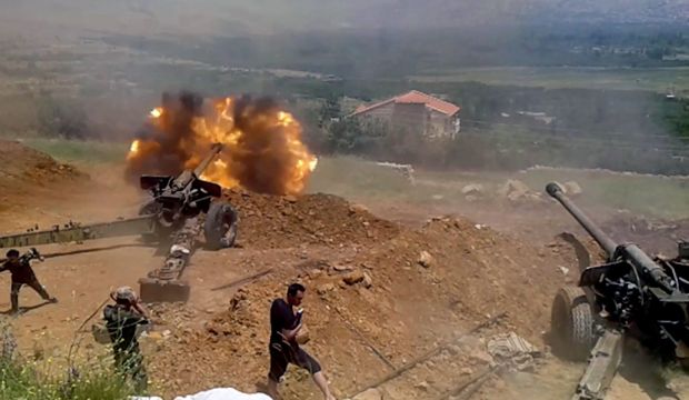 A handout picture made available by Syrian Arab news agency SANA shows Syrian army soldiers during a artillery operations in Al-Zabadani area in western rural Damascus, Syria, on 9 July 2015. (EPA/SANA HANDOUT)