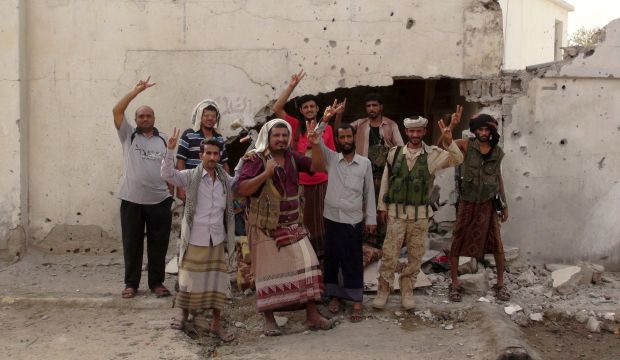 Southern Popular Resistance fighters flash the victory sign at the international airport of Yemen's southern port city of Aden on July 15, 2015. (Reuters/Stringer)