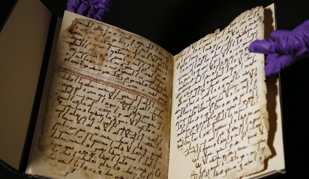 A university assistant shows fragments of an old Qur'an at the University of Birmingham, in Birmingham central England on Wednesday, July 22, 2015. (AP Photo/Frank Augstein)