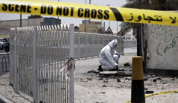 A Bahraini forensic police officer inspects the site of a bomb blast in the village of Sitra, south of Manama, on July 28, 2015. (AFP Photo/Mohammed Al-Shaikh)