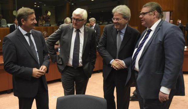 (L–R) Slovenia Foreign Minister Karl Erjavec, German Foreign Minister Frank-Walter Steinmeier, Italian Foreign Affairs Minister Paolo Gentiloni, and Finnish Foreign Minister Timo Soini talk with one another during a foreign affairs meeting at the European Union headquarters in Brussels, Belgium, on July 20, 2015. (AFP Photo/John Thys)