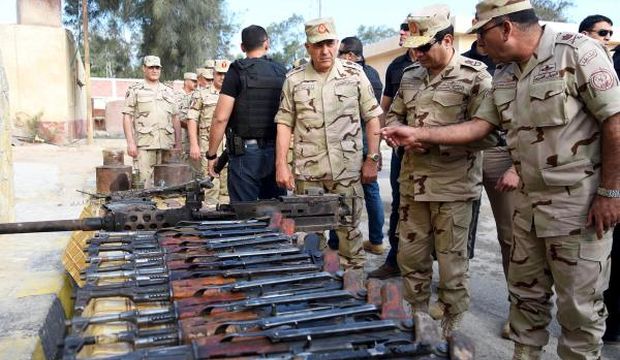 A handout picture made available by the Office of the Egyptian President shows Egyptian President Abdel-Fattah El-Sisi (C) inspecting weapons allegedly captured from militants, during his official visit following unprecedented attacks in North Sinai, Egypt, on July 4, 2014. (EPA/Office of the Egyptian President/HO)