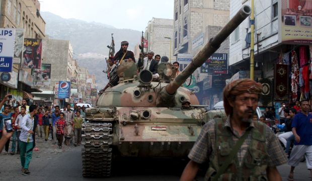 Militants loyal to Yemen's exiled government ride atop a tank they seized from Houthi militiamen in the country's central city of Taiz on August 17, 2015. (REUTERS/Stringer)     