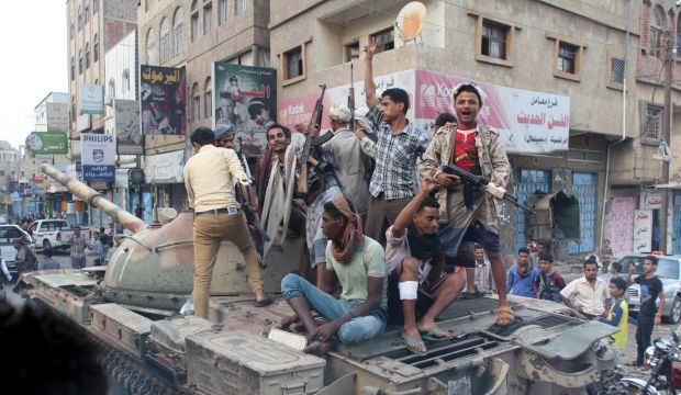 Militants loyal to Yemen's exiled government ride atop a tank they seized from Houthi militiamen in the country's central city of Taiz on August 17, 2015. (REUTERS/Stringer)