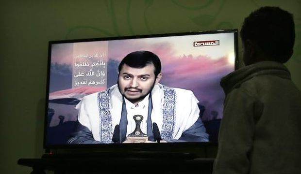 A Yemeni watches Houthi leader Abdul Malik Al-Houthi delivering a speech on the pro-Houthi Al-Masirah TV channel, after his fighters were driven out from most of the southern port city of Aden, in Sana'a, Yemen, on August 2, 2015. (EPA/Yahya Arhab)