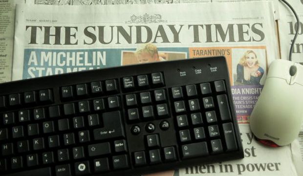 A copy of the London-based Sunday Times newspaper rests under a computer keyboard and mouse, on August 7, 2009, in London, United Kingdom. (Getty Images/Peter Macdiarmid)