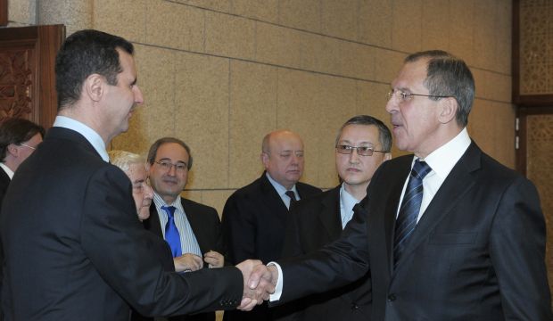 In this Feb. 7, 2012 file photo, Syrian President Bashar Al-Assad, left, shakes hands with Russian Foreign Minister Sergei Lavrov after talks in Damascus, Syria. (AP Photo/Pool, File)