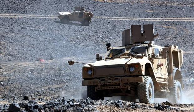 A picture made available on September 14, 2015 shows Saudi-led coalition military vehicles driving through rocky terrain during the offensive against Houthi positions in the oil-rich central Ma’rib province, Yemen, on September 13, 2015. (EPA/STR)