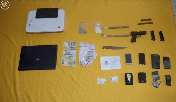 Devices along with money and pistols, said to be seized by Saudi security forces after arresting suspected Islamic State of Iraq and Syria (ISIS) militants, are seen in this handout photo provided by the Saudi Press Agency (SPA), on September 28, 2015. (Reuters/HO/SPA) 