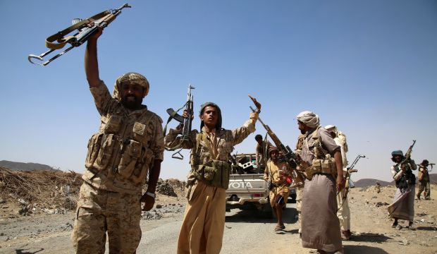Armed Yemeni tribesmen from the Popular Resistance Committees, supporting forces loyal to Yemen's Saudi-backed President Abd Rabbuh Mansur Hadi, jubilate on a road after seizing control of an area in Ma'rib province, east of the capital Sana'a, on October 5, 2015.  (AFP PHOTO / ABDULLAH AL-QADRY)