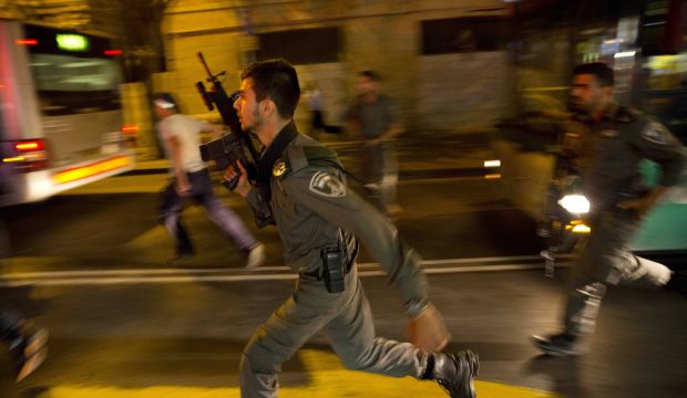 In a Wednesday, October 14, 2015 file photo, Israeli policemen run looking for a possible stabbing suspect in Jerusalem.  (AP Photo/Dusan Vranic, File)