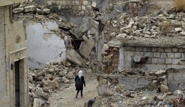 A school girl walks past damaged buildings in the rebel-controlled area of Ma'aret Al-Numan town in Idlib province, Syria, on October 28, 2015. (REUTERS/Khalil Ashawi)