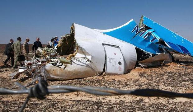A handout picture provided by the Russian Emergency Ministry press service on November 2, 2015 shows Russian Emergency Situations Minister Vladimir Puchkov (4-L) and unidentified officials near a piece of wreckage of Russian MetroJet Airbus A321 at the site of the crash in Sinai, Egypt, on November 1, 2015. (EPA/Maxim Grigoriev/Russian Emergency Ministry/HO)