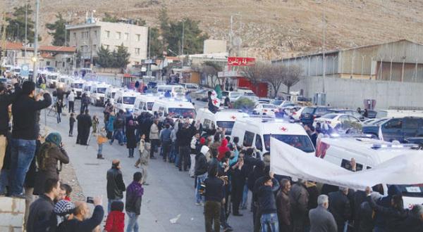 A convoy of ambulances carrying fighters and the wounded from the besieged region Al-Zabadani to the Syrian-Lebanese border (Reuters)