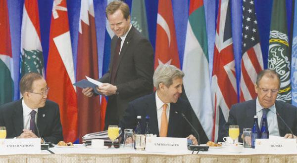 US Secretary of State John Kerry speaks to his Russian counterpart Sergey Lavrov before the start of the meeting on Syria in New York yesterday (AFP)