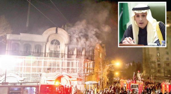 Smoke rising from the Saudi Embassy in Tehran after the attack on it yesterday (AP). Inset: Al-Jubeir speaks at a press conference in Riyadh yesterday (Photo: Abdul Rahman Al-Salem)