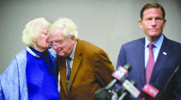 Former American hostage taken in Iran Moorhead Kennedy listens to his wife at a press conference in Hartford, USA where a deal regarding Iranian compensation for former hostages was announced (AP)