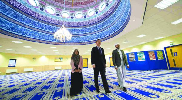 Cameron during his visit to Mecca Mosque in Leeds, England yesterday with the Imam of the mosque Mr Asim and Shabana Munir, a member of the women’s committee of the mosque (Reuters)