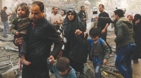 Civilians in Aleppo rush to safety after an air strike 