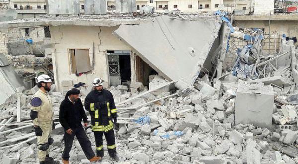 Rescue workers inspect the damage caused by Russian air raids on the city of Idlib yesterday (Getty)