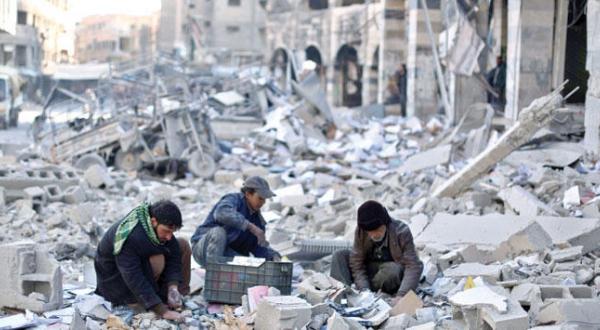 Young residents of rural Damascus looking for belongings in the rubble of a municipal building which was targeted by an air strike carried out by the regime on Wednesday (EPA)
