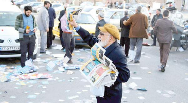 Iranian man spreading flyers for election campaigns in Tehran Feb 23-EPA