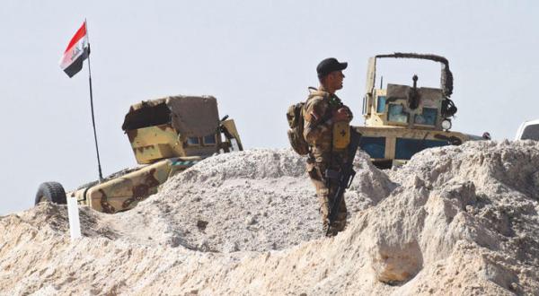 An Iraqi soldier watching a military operation in a village in Fallujah, governorate of Al-Anbar (EPA)