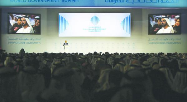 The World Bank President Dr Jim Yong Kim giving a speech at the World Government Summit in Dubai yesterday and Sheikh Mohammed bin Rashid Al Maktoum, the Prime Minister and Ruler of Dubai, appears on a giant screen (AFP)