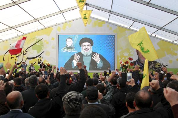 Lebanon's Hezbollah leader Sayyed Hassan Nasrallah addresses his supporters via a screen during a commemoration service marking one week since the death of Ali Fayyad, one of Hezbollah's senior commanders killed fighting alongside Syrian army forces in Syria, in Ansar village, southern Lebanon March 6, 2016. REUTERS/Aziz Taher