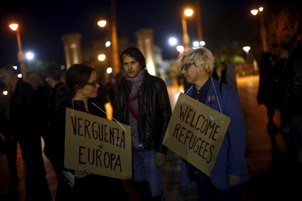 People stand during a protest against the EU-Turkey migrant deal in Malaga, southern Spain, March 16, 2016. The sign (L) reads, "Shame of Europe". REUTERS/Jon Nazca