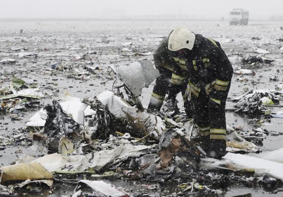 Emergencies Ministry members search the wreckage at the crash site of Flight number FZ981, a Boeing 737-800 operated by Dubai-based budget carrier Flydubai, at the airport of Rostov-On-Don, Russia, March 19, 2016. REUTERS/Stringer