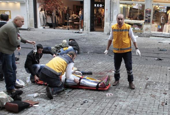 A man is helped by emergency services following a suicide bombing in a major shopping and tourist district in central Istanbul March 19, 2016. REUTERS/Kemal Aslan