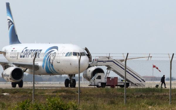 An unidentified person (R) pulls a suitcase after leaving the hijacked EgyptAir A320 plane at a sealed off area of the Larnaca Airport, in Larnaca, Cyprus, 29 March 2016.- EPA/KATIA CHRISTODOULOU