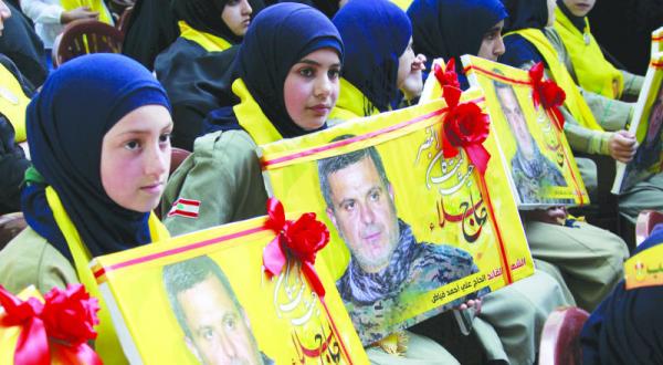 A Hezbollah Scout troop participating in a march in southern Lebanon yesterday in commemoration of Ali Fayyad, a leader of the party who was killed in Syria last week (Reuters)