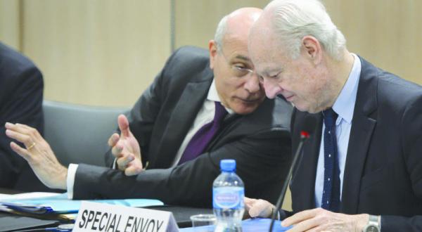 The UN envoy to Syria Staffan de Mistura talks to Ezzedine Ramzy during negotiations on Syria in Geneva (Reuters)