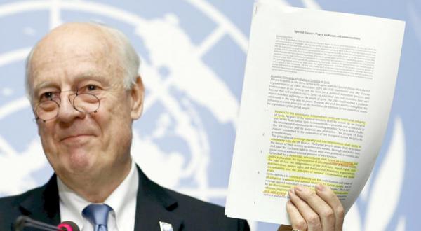 UN envoy to Syria Staffan de Mistura holds a document containing a political solution to the Syrian crisis during a press conference at the end of the peace talks in Vienna yesterday (Reuters)
