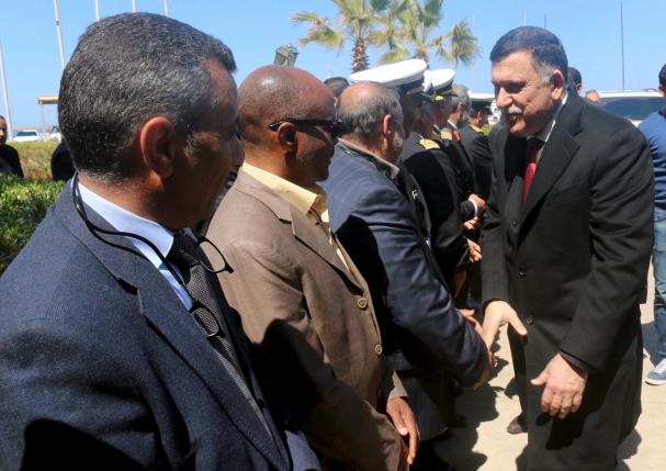 Libyan Prime Minister-designate Fayez Seraj (R) is greeted upon arrival in Tripoli, Libya March 30, 2016. REUTERS/Hani Amara
