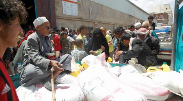 Yemeni people recieving food aid in Sana'a on March 16 A.F.P