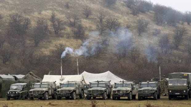Russia holds war games near Ukraine, Merkel warns of catastrophe