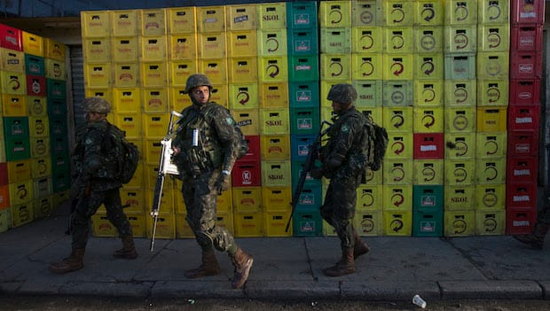 Brazil security forces raid Rio slum before World Cup