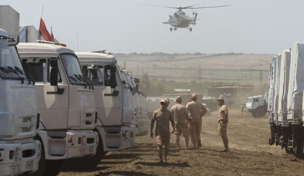 Russian aid convoy checked; military vehicles mass near Ukraine